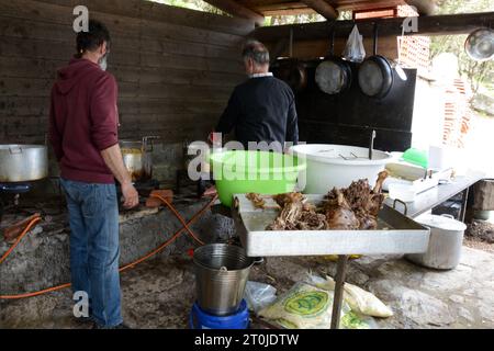 Greek men in a 'blue zone' preparing the food at the panigiri (village festival) of Agios Isidoros (Saint Isidore), near Pezi, Ikaria island, Greece. Stock Photo