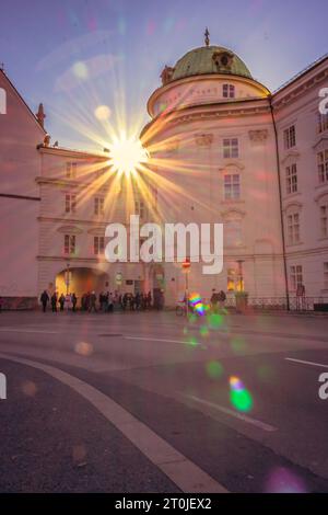 Imperial palace in Innsbruck with unknown tourists. Hofburg tour on sunset. Innsbruck landmark in evening sunlight. Imperial architecture. Stock Photo