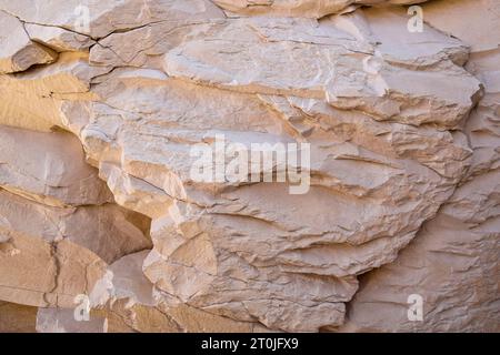 Brown Natural Sand Stone Texture and Background. Layered stone texture in beige tones with many cracks, full frame. Close-up. Selective focus. Stock Photo