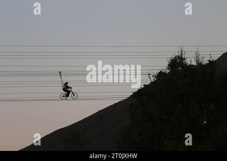 Hir, Ardabil, Iran. 5th Oct, 2023. An Iranian rides a bicycle along a cable in the Heer recreation area near the city of Ardabil. Iran was elected as the tourism capital of the ECO countries in 2023. (Credit Image: © Rouzbeh Fouladi/ZUMA Press Wire) EDITORIAL USAGE ONLY! Not for Commercial USAGE! Stock Photo