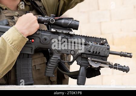 Israeli assault rifle or machine gun in soldier's hands Stock Photo