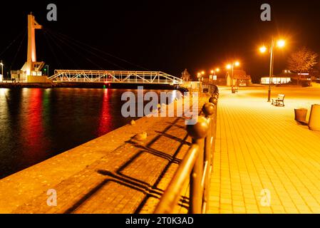 illuminated footbridge in the harbor at night Stock Photo