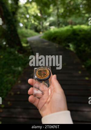 hand holding a compass in nature Stock Photo