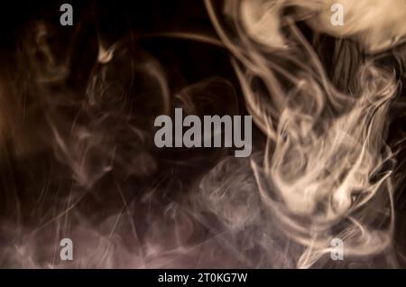 Puffs of smoke on black isolated background Stock Photo