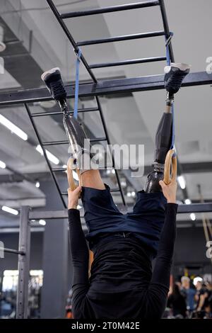 gorgeous athlete doing intense workout at the gym on gymnastic rings cropped shot,coordination, Spiderman Stock Photo