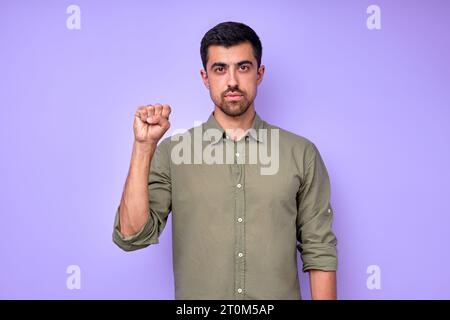 closeup portrait view of man showing yes sign in deaf language, body language, serious guy with raised fist looking at camera, approval Stock Photo