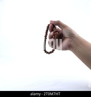 hand holding prayer beads Stock Photo