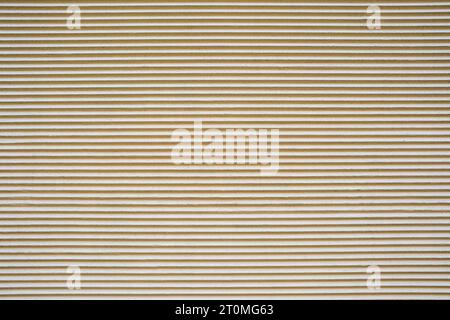 Background from a beige plastered wall with a corrugated profile Stock Photo