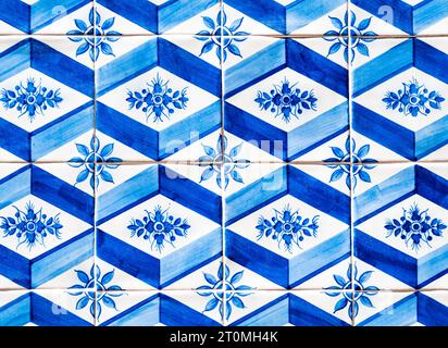 Typical tiles with blue and white rhomboidal shapes and floral themes, adorning the facades of the houses in Porto, Portugal Stock Photo