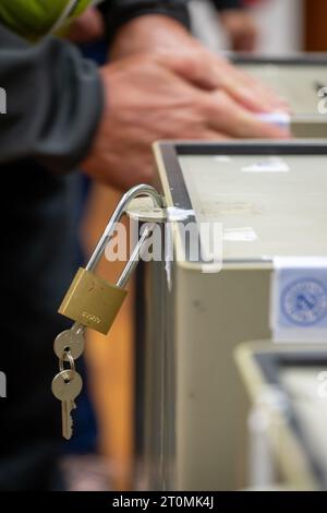 Untermerzbach, Germany. 08th Oct, 2023. A padlock hangs on a ballot box, another is sealed with an election seal of the Free State of Bavaria. In Bavaria, the election for the 19th Bavarian State Parliament takes place on Sunday. Credit: Pia Bayer/dpa/Alamy Live News Stock Photo