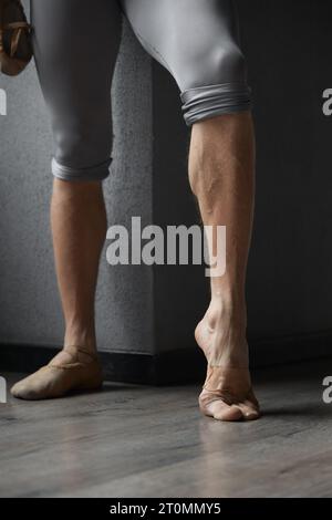 Strong trained legs of male ballet dancer cropped shot Stock Photo