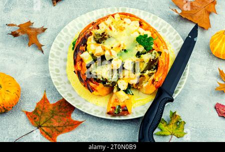 Half baked squash stuffed with mushrooms, spinach and artichoke. Autumn recipe Stock Photo