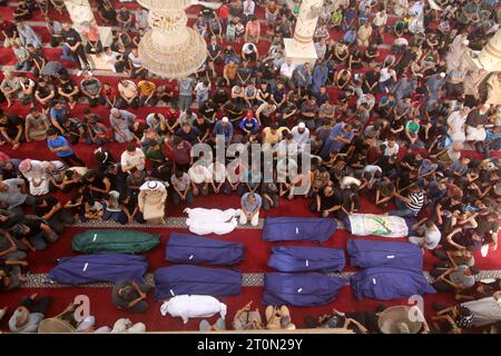 Rafah, Palestine. 8th Oct 2023. People gather at a mosque to pray over the bodies of the Abu Quta family and their neighbours, killed in Israeli strikes on the Palestinian city of Rafah People gather at a mosque to pray over the bodies of the Abu Quta family and their neighbours, killed in Israeli strikes on the Palestinian city of Rafah in the southern Gaza Strip, during their funeral on October 8, 2023. Credit: Imago/Alamy Live News Stock Photo