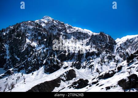 Kashmir Snow mountains. Nestled within the picturesque Kashmir valley, breathtaking sight, with the majestic snow-capped Himalayan mountains Stock Photo