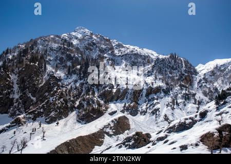 Kashmir Snow mountains. Nestled within the picturesque Kashmir valley, breathtaking sight, with the majestic snow-capped Himalayan mountains Stock Photo