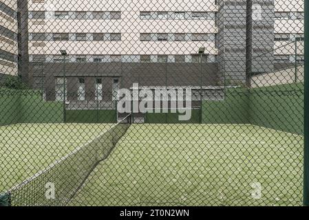 Paddle tennis court closed with metal fences, light bulbs Stock Photo