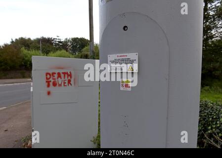 Graffiti stencils of 5g mobile phone mast conspiracy theory about health and emp concerns on cell phone antenna equiment in Chepstow, Wales Stock Photo