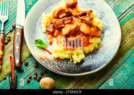 Beef meat stew in sauce with mashed potatoes. Goulash Stock Photo