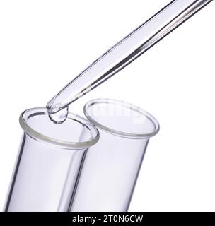 A drop of liquid is dropped from a pipette into a test tube Stock Photo
