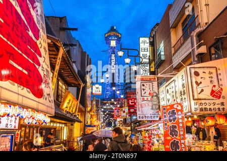 October 8, 2023: Street view of Shinsekai and Tsutenkaku tower in Osaka, Japan. Shinsekai, lit. New World, is a retro area developed before the war an Stock Photo