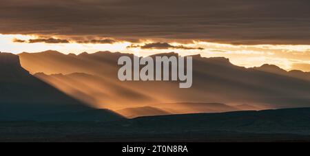 Orange Light Breaks Over The Sierra Del Carmen Mountains in Big Bend National Park Stock Photo