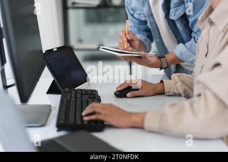Two developer programmer typing code and writing data while discussing about programming website. Stock Photo