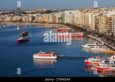 Sliema, Malta - October 17, 2019: Sliema town skyline at Marsamxett Harbour with tour and cruise passenger boats, view from above. Stock Photo
