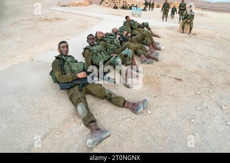 Masada, Israel. 23 October 2018: Israeli male soldiers resting on the ground after military exercises on Masada fortress territory Stock Photo