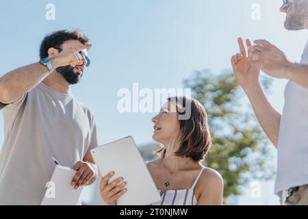 Collaborative team of architects and construction engineers discussing blueprints, statistics and costs for a modern construction project in the city. Stock Photo