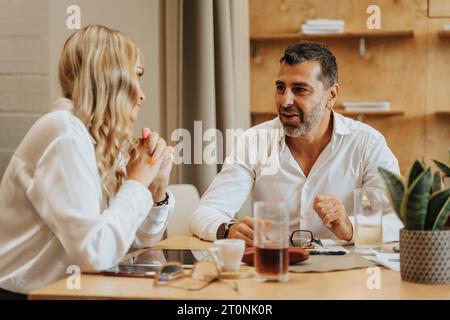 Middle-aged business partner discussing the next project. Negotiations going well Stock Photo