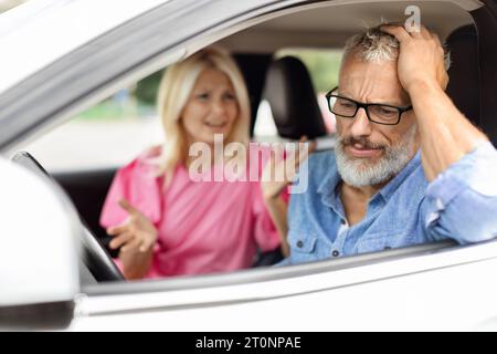 Stressed elderly man sitting in car, have fight with wife Stock Photo