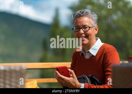 Woman smiling and holding the phone Stock Photo