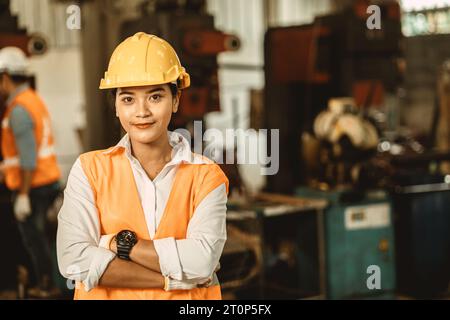 Happy women engineer Asian worker female work in factory portrait smile standing arm fold confidence look Stock Photo