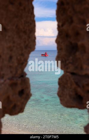 Poseidon Submarine boat mid tour departing from Mandraki Harbor viewed from a window hole in the city's fortress Stock Photo