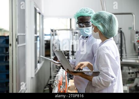 Drink beverage factory QC audit staff quality control worker team working. Hygiene officer clean standard check process inspection in plant production Stock Photo
