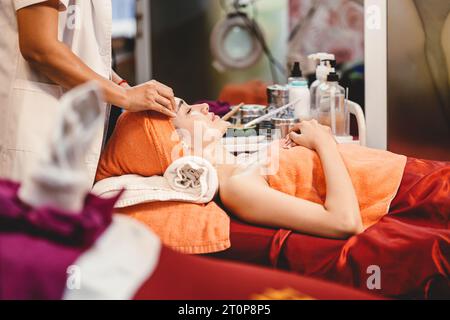 Asian woman in spa salon face massage for facial beauty skin care Stock Photo