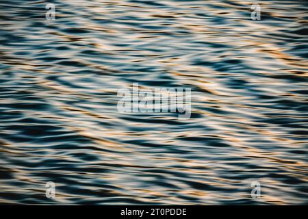Beautiful sea waves at sunset, motion blur. Quiet sea with sun reflections, copy space, fine art Stock Photo