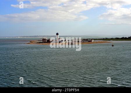 Calshot Spit taken from Southampton Water with the Isle of Wight, Calshot Castle, the Lifeboat station and Coastguard Control Tower visible. Stock Photo