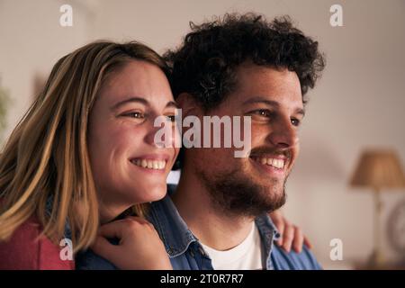 Close up of cheerful faces of young adult Caucasian romantic couple smiling at home. People in love. Stock Photo