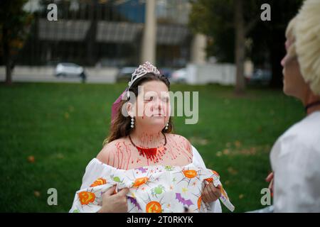 November 2, 2016 - Indianapolis, Indiana, USA: A women's rights activist sprays fake blood on a fellow activist before Periods for Politicians formerly Periods for Pence stage an anti-Trump and anti-Pence The Revolution Will Be Uterized (A Rally in 3 Acts) on the steps of the Indiana Statehouse. Stock Photo