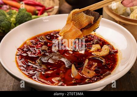 Close up of a popular Chinese Sichuan province cuisine Sliced Duck Blood in Chili Sauce oil with lunch meat, tripe and eel slices (Chinese: Maoxuewang Stock Photo