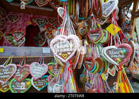 Munich, Germany, EU - Sept. 18, 2023. Traditional German heart shaped gingerbread cookies, gingerbread cakes with icing, at Oktoberfest beer festival. Stock Photo