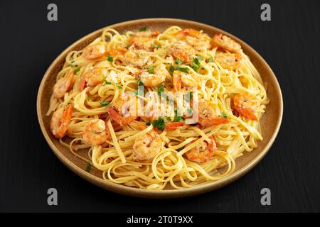 Baked Shrimp Scampi Linguine Pasta with Parsley on a Plate, side view. Stock Photo