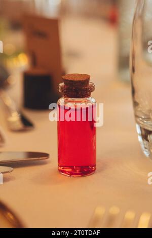 Wedding table decorations - A shot in a small medicine jar Stock Photo
