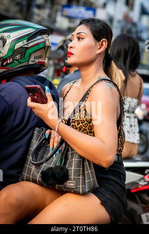 Local Thai people, tourists and residents rush past the busy junction of Soi Buakhao and Soi Lengkee in Pattaya Thailand on mopeds and motorbikes. Stock Photo