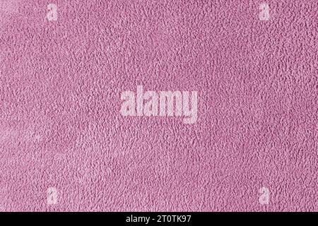 Terry cloth, pink towel texture background. Soft fluffy textile bath or beach towel material. Top view, close up. Stock Photo