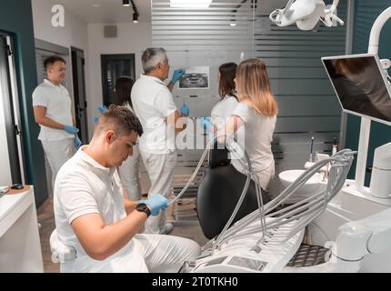 Dentists work in dental office. Doctors discuss treatment plan and consult and consult with colleagues and with each other. Medical meeting in clinic Stock Photo