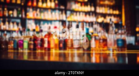 blurred alcohol bottles on bar counter and in shelves in background Stock Photo