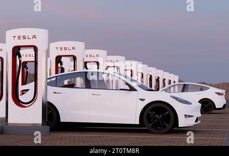 Charging a Tesla Model Y at a Tesla Supercharger fast charging station Stock Photo