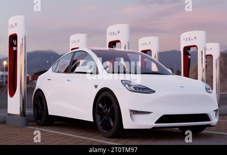 Charging a Tesla Model Y at a Tesla Supercharger fast charging station Stock Photo